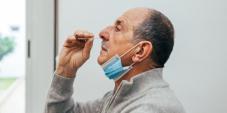 Man self-administering a rapid Covid-19 test