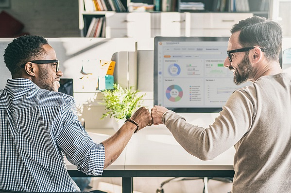 two people bumping fists as part of a Contact Center as a Service